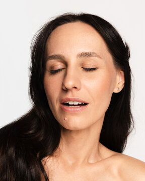 Woman eyes closed experiencing peace and tranquility