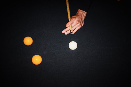 Player Makes a Shot in a Game of Billiards