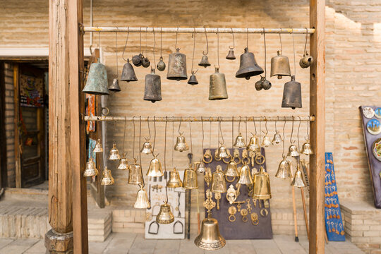 Decorative Bells Hang on Display in a Market in Uzbekistan