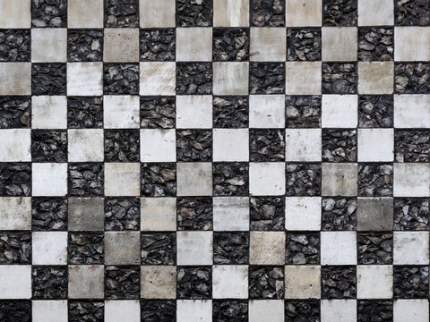 Chequerboard stone pattern on medieval church for use as a background texture