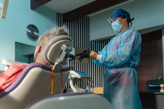 Dental professional preparing for checkup with patient
