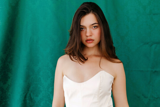 Young woman with brown hair looking directly