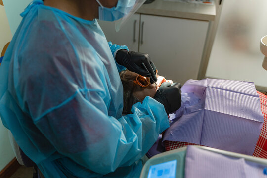 Dentist conducting check-up on patient at clinic
