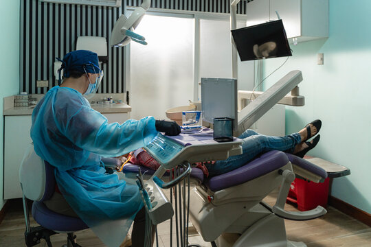 Dentist providing treatment in clinic environment