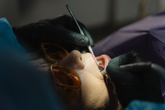 Dental professional operating on teeth of a patient
