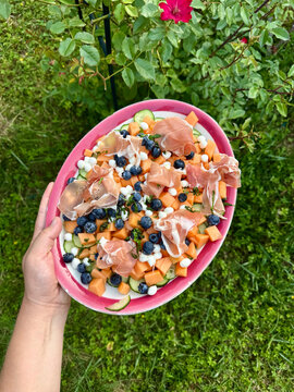 Fresh Fruit and Prosciutto Platter Held in a Garden Setting