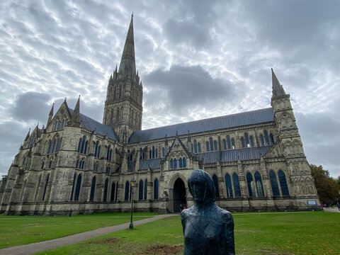 Salisbury Cathedral exterior with tallest church spire in United Kingdom. Early English Gothic structure with clerestory windows and North transept.