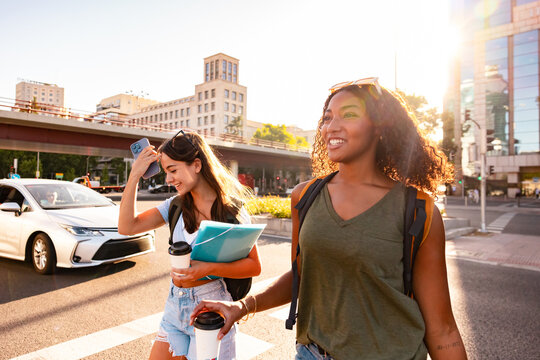 Teenage girls walking with backpacks and folders