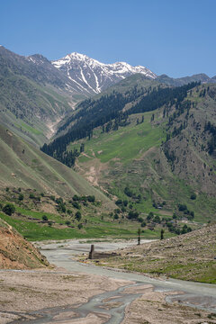 Vertical mountain landscape view with river and snowcapped peak near Naran, Kaghan valley, Khyber Pakhtunkhwa, Pakistan