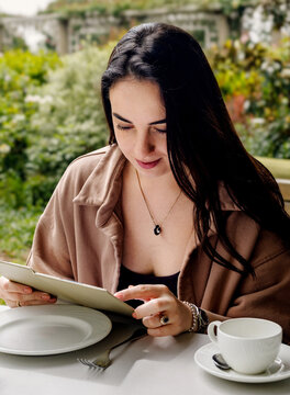A portrait of a beautiful girl in a garden caffee