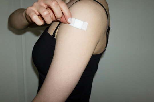 Conceptual image of person has taken the vaccination & having plaster