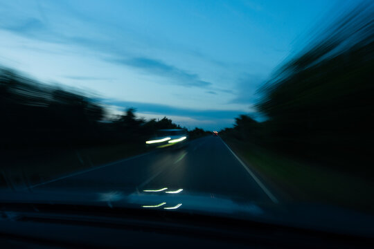 Driving Along Empty Country Road at Blue Hour