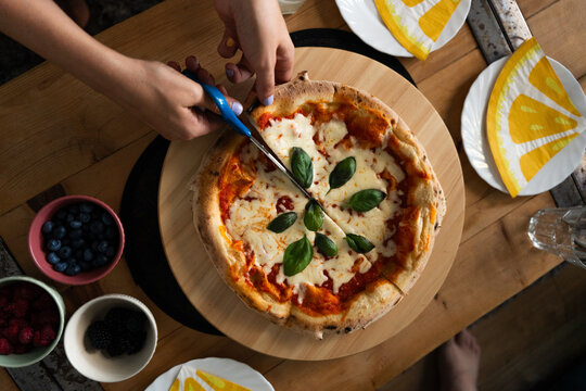 Homemade Margherita Pizza Shared at Dining Table