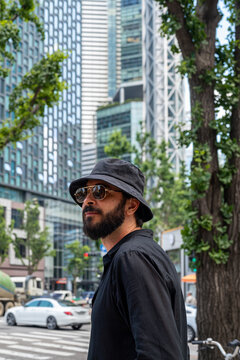 Stylish Man in Bucket Hat and Sunglasses in Seoul