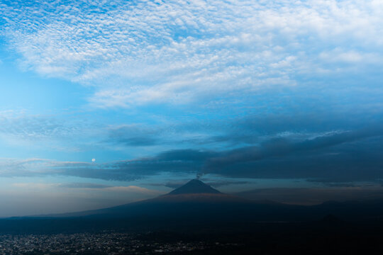 Popocatepetl volcano erupting during sunrise over puebla
