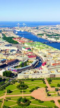 Vertical video. St Petersburg, Russia. Aerial panoramic sweep over the historic centre, geometric lawns of the Field of Mars, the Winter Palace, and the Neva River under clear summer skies. Drone foo