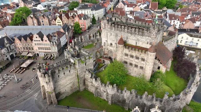 Aerial drone view of Ghent old town in Belgium, with the towers of St. Nicholas and St. Michael's Churches and Castle of the Counts next to river Lys. Architecture and landmarks of the medieval city.