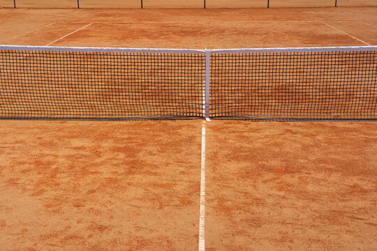  A yellow tennis ground court grande arena with tennis net.