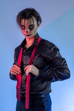 young guy with skull makeup celebrating a Halloween party