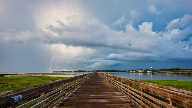 Lightning strikes over the pier during a stormy day on the waterfront
