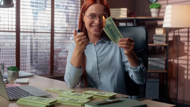 Caucasian crazy business woman burning cash money in corporate office financial spending bribe concept excited businesswoman burn dollars with fire female girl with banknotes in flame financial fraud