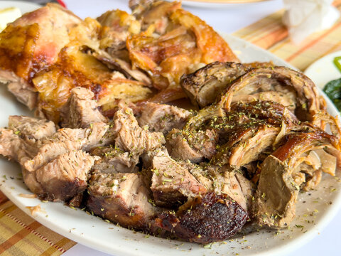 Traditional Greek Easter meat platter with kokoretsi roast lamb and pork kontosouvli closeup view