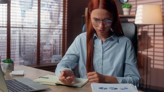 Pensive Caucasian business woman analyzing stats diagrams comparing data in laptop and documents thinking in company concentrated businesswoman working female girl executive work with papers in office