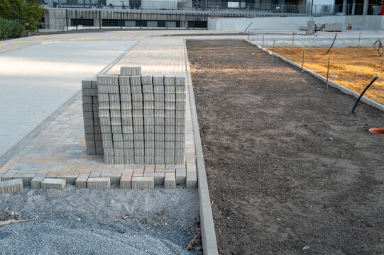 Stacking paving stones for new sidewalk construction