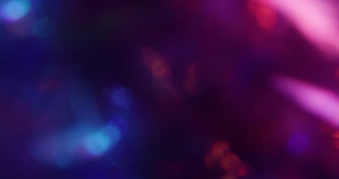 Defocused bright glare. Neon glimmer art. Pink purple blue colorful lens flare shiny rainbow gleam kaleidoscope on light abstract bokeh background.
