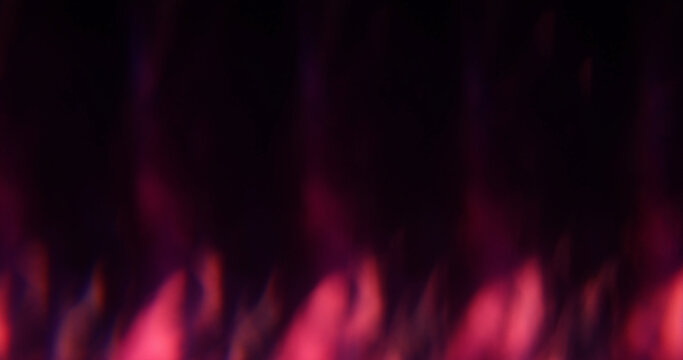 Defocused kaleidoscope flare. Colorful abstraction. Pink blue purple round optical glisten on luminous bokeh dark black background.