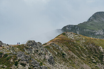 Obraz premium Trekkers Walking On Mountain Trail Towards Brevent Ridge In Misty Alpine Landscape French Alps Chamonix Valley High Altitude Hiking Route Scenic Vista Outdoor Adventure Extreme Trekking Experience