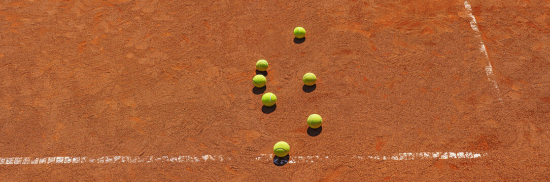  A yellow tennis balls lies on the clay court. Sport banner with copy sapce.