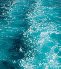 Fresh blue ocean waves viewed from above, featuring turquoise water, white foam and a beautiful...