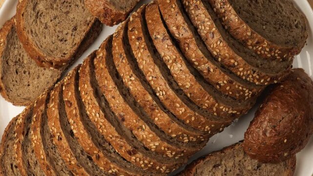 Sliced whole grain bread with seeds rotating