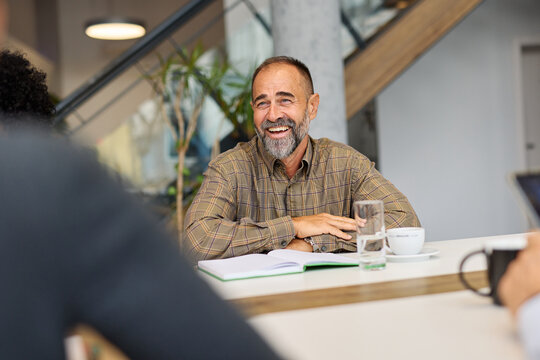 Businesspeople having a meeting in the office. Teamwork and success concept, portrait of a smart mid aged  businessman, two businesspeople talking planning brainstorming