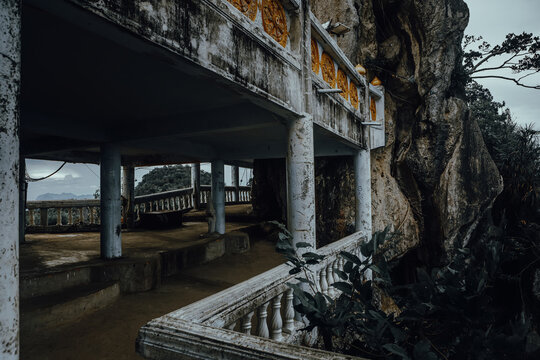 Aged stone pavilion terrace on a cliff side at Wat Tham Suea in Krabi, Thailand