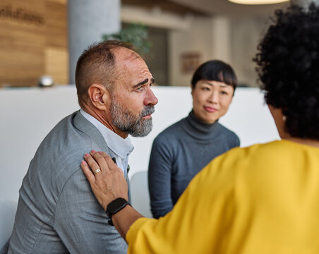 Group psychotherapy. Persons sitting in circle and talking. People meeting. Psychotherapy training, business lecture or conference. Man woman support group. Young businesspeople having a meeting in th