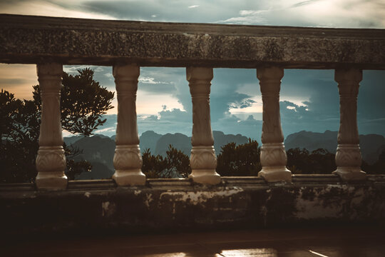 Sunset mountain landscape view through a stone balustrade in Krabi, Thailand