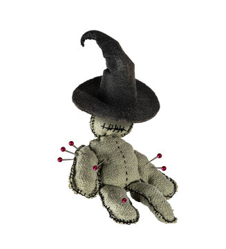Homemade voodoo doll in a conical witch hat, Halloween decor on isolated background.