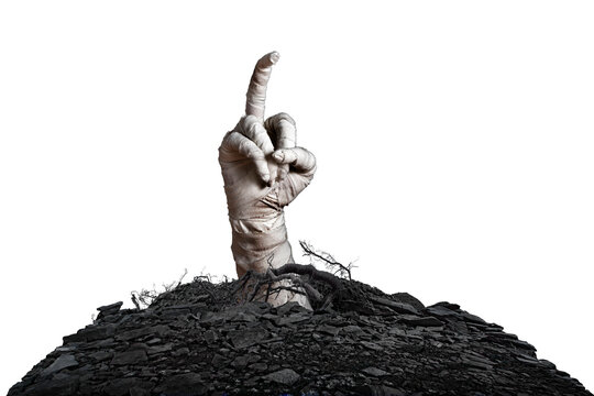 Mummy's hand wrapped in a bandage obscene gesture reaches up through the ground grave on isolated background. The hand of the mummy monster for Halloween horror concept
