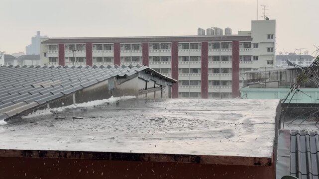 BANGKOK, THAILAND - APRIL 2026 : View of heavy squall raining down on the city street. Concept of tropical climate weather, torrential storm and sudden monsoon downpour.