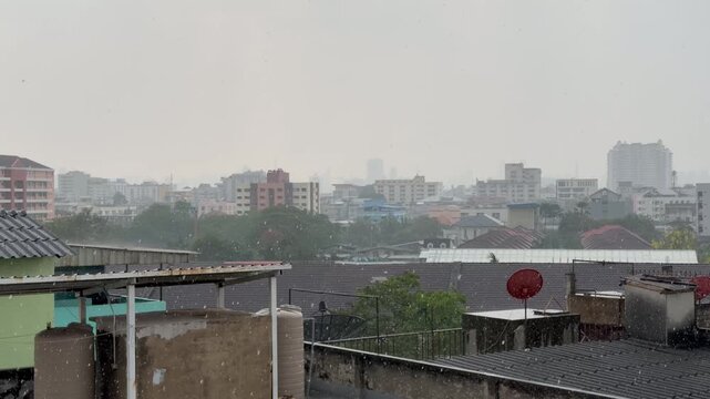 BANGKOK, THAILAND - APRIL 2026 : View of heavy squall raining down on the city street. Concept of tropical climate weather, torrential storm and sudden monsoon downpour.