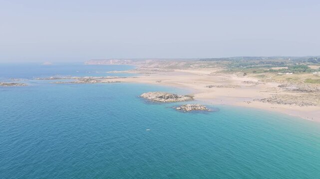 Aerial view of the expansive sandy beach and turquoise waters of Anse du Croc in Frehel, Brittany, France.
