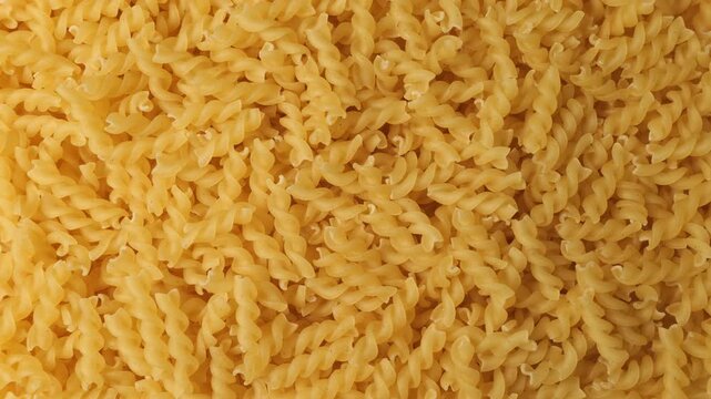 Uncooked fusilli pasta texture background shot
