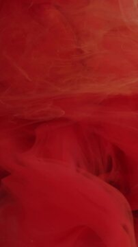 Vertical video. Flowing fog. Vapor background. Defocused yellow pink color paint in liquid water chemical fluid spreading on art abstraction.