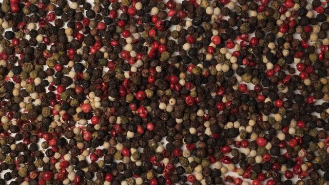 Dolly shot over a mix of colorful peppercorns
