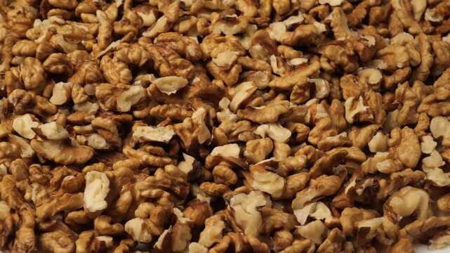 Rotating pile of shelled walnuts closeup