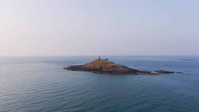 Aerial view of Ilot Saint Michel, a small rocky island off the coast of Erquy in Brittany, France, featuring the historic chapel at its summit.
