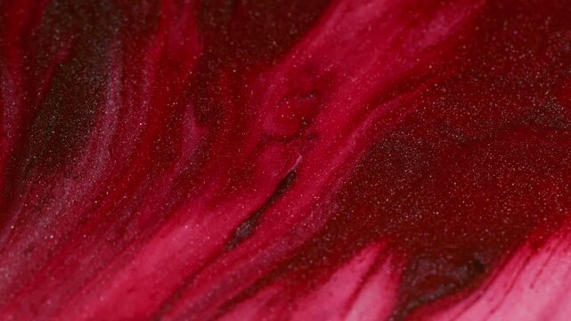 Ink drip. Flow shimmer. Defocused red pink color vibrant wet particles droplets floating on abstract creative acrylic art background.