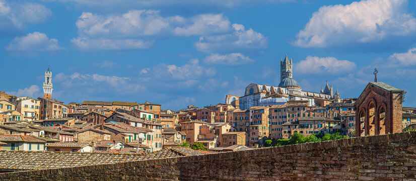 Siena, Province of Siena, Italy. Panoramic view of the old medieval city of Siena, also called the open-air museum city of Italy. In the background the Siena Cathedral (Duomo di Siena).